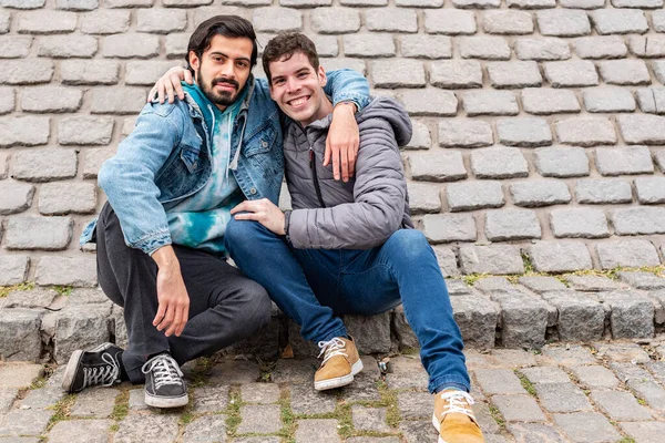 Two Male Friends Hugging Looking Camera Outdoors Copy Space — Stock Fotó