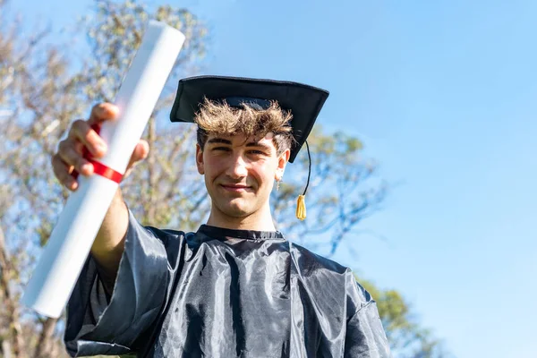 Happy Graduated Young Man Wearing Bachelor Gown Black Mortarboard Showing — 스톡 사진