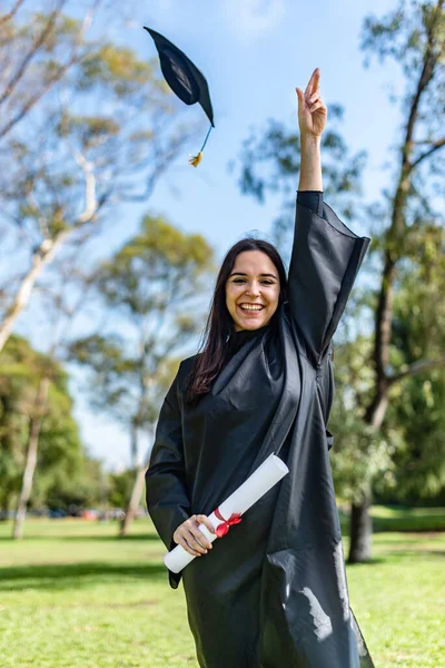 Happy Caucasian Graduated Girl Black Gown Throwing Mortarboard Sky — Fotografia de Stock