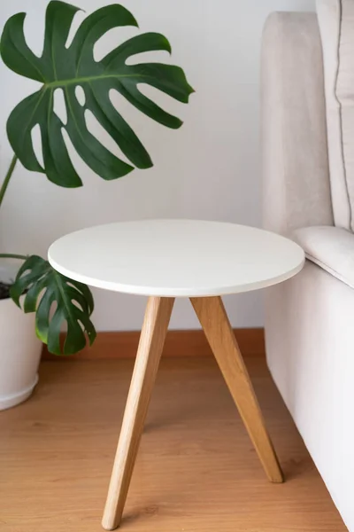 Round coffee table isolated near the couch