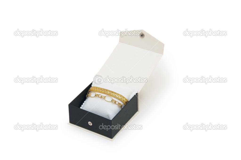 Golden bracelets in a box isolated on white background