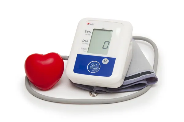 Digital blood pressure meter with love heart symbol on white background — Stock Photo, Image