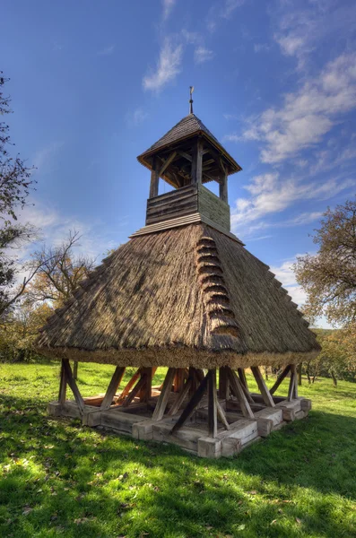 Wooden bell tower wit thatch — Stock Photo, Image
