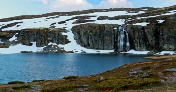 Aurlandsfjellet, Norway. Waterfall And Lake Flotvatnet In Spring Snowy Landscape. Scenic Route Road In Summer Norwegian Landscape. Natural Norwegian Landmark And Popular Destination — Stock Video