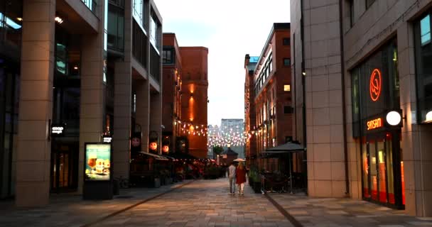 Oslo, Norway - June 23, 2019: People Walking Near Residential Multi-storey Houses In Aker Brygge District In Summer Evening. Famous And Popular Place. 4K — Stock Video