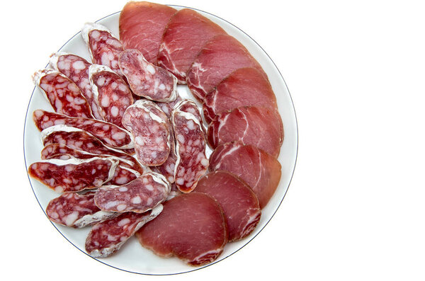 Smoked cut sausage with cut sirloin on plate isolated on white background