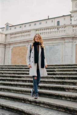 Young blonde woman exploring the streets of Europe