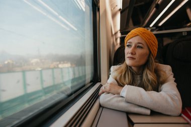blonde woman sitting in the train