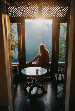 woman sitting at looking ar sunset