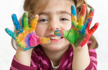 Preschool girl with painted hands clipart