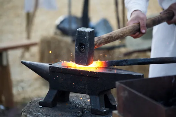 Blacksmith working hot iron — Stock Photo, Image