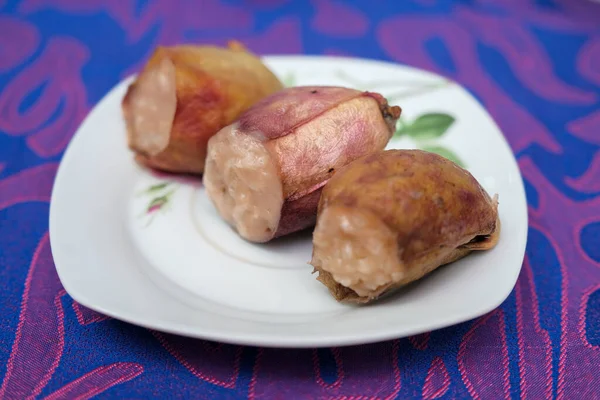 Glutinous rice steamed cooked with coconut milk in pitcher plants known as lemang periuk kera with spicy chicken rendang. A traditional malay cuisine during Hari Raya festival.