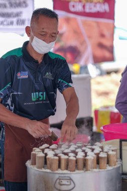 Segamat, Malaysia- April 2nd, 2022 : Muslim male vendors cooking and  selling halal foods from roadside stall  in holy month of Ramadan at Kuantan.
