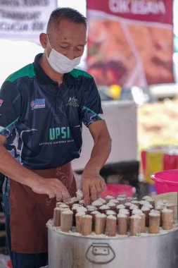 Segamat, Malaysia- April 2nd, 2022 : Muslim male vendors cooking and  selling halal foods from roadside stall  in holy month of Ramadan at Kuantan.