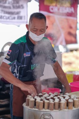 Segamat, Malaysia- April 2nd, 2022 : Muslim male vendors cooking and  selling halal foods from roadside stall  in holy month of Ramadan at Kuantan.