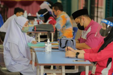 Muadzam Shah, Malaysia - April 7th, 2022 :  Happy muslim student with protective mask during  student enrolment day.