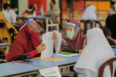 Muadzam Shah, Malaysia - April 7th, 2022 :  Happy muslim student with protective mask during  student enrolment day.