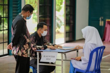 Muadzam Shah, Malaysia - April 7th, 2022 :  Happy muslim student with protective mask during  student enrolment day.
