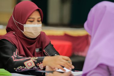 Muadzam Shah, Malaysia - April 7th, 2022 :  Happy muslim student with protective mask during  student enrolment day.