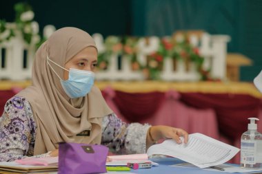 Muadzam Shah, Malaysia - April 7th, 2022 :  Happy muslim student with protective mask during  student enrolment day.