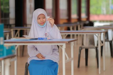 Muadzam Shah, Malaysia - April 7th, 2022 : Lateral-Flow-Test covid rapid home-use test kit for saliva - step 2 - spit with mouth through funnel in plastic tube to collect sample.