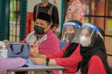Muadzam Shah, Malaysia - April 7th, 2022 :  Happy muslim student with protective mask during  student enrolment day.