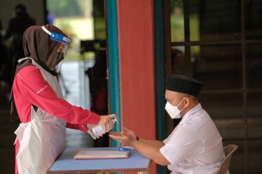 Muadzam Shah, Malaysia - April 7th, 2022 : New students made a quick Covid-19 test by placing saliva and fluid buffer observations during student enrolment day.