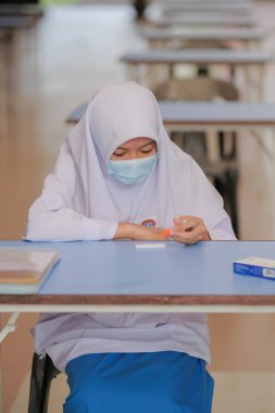 Muadzam Shah, Malaysia - April 7th, 2022 : New students made a quick Covid-19 test by placing saliva and fluid buffer observations during student enrolment day.
