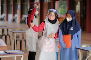 Muadzam Shah, Malaysia - April 7th, 2022 :  Happy muslim student with protective mask during  student enrolment day.