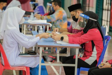 Muadzam Shah, Malaysia - April 7th, 2022 :  Happy muslim student with protective mask during  student enrolment day.