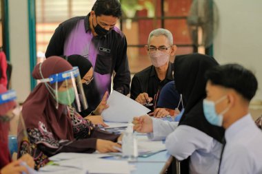Muadzam Shah, Malaysia - April 7th, 2022 :  Happy muslim student with protective mask during  student enrolment day.