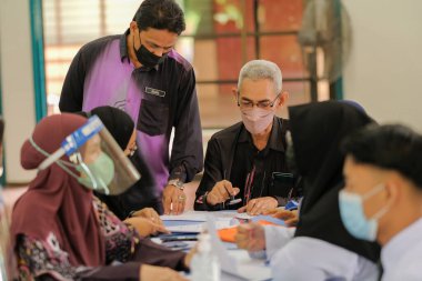 Muadzam Shah, Malaysia - April 7th, 2022 :  Happy muslim student with protective mask during  student enrolment day.
