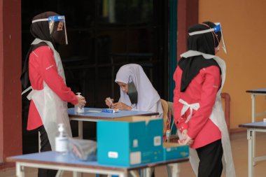 Muadzam Shah, Malaysia - April 7th, 2022 : New students made a quick Covid-19 test by placing saliva and fluid buffer observations during student enrolment day.