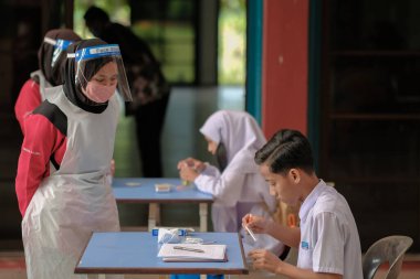 Muadzam Shah, Malaysia - April 7th, 2022 : New students made a quick Covid-19 test by placing saliva and fluid buffer observations during student enrolment day.