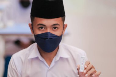 Muadzam Shah, Malaysia - April 7th, 2022 : New students made a quick Covid-19 test by placing saliva and fluid buffer observations during student enrolment day.