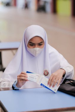 Muadzam Shah, Malaysia - April 7th, 2022 : New students made a quick Covid-19 test by placing saliva and fluid buffer observations during student enrolment day.