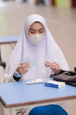 Muadzam Shah, Malaysia - April 7th, 2022 : New students made a quick Covid-19 test by placing saliva and fluid buffer observations during student enrolment day.