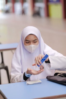 Muadzam Shah, Malaysia - April 7th, 2022 : New students made a quick Covid-19 test by placing saliva and fluid buffer observations during student enrolment day.