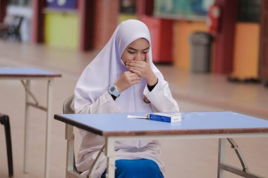 Muadzam Shah, Malaysia - April 7th, 2022 : Lateral-Flow-Test covid rapid home-use test kit for saliva - step 2 - spit with mouth through funnel in plastic tube to collect sample.