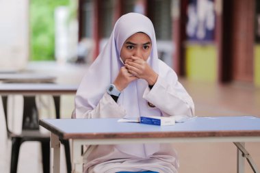 Muadzam Shah, Malaysia - April 7th, 2022 : Lateral-Flow-Test covid rapid home-use test kit for saliva - step 2 - spit with mouth through funnel in plastic tube to collect sample.