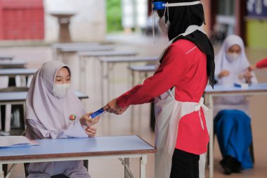 Muadzam Shah, Malaysia - April 7th, 2022 : New students made a quick Covid-19 test by placing saliva and fluid buffer observations during student enrolment day.