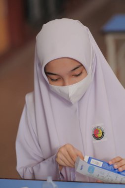 Muadzam Shah, Malaysia - April 7th, 2022 : New students made a quick Covid-19 test by placing saliva and fluid buffer observations during student enrolment day.