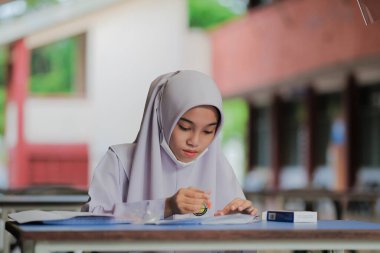 Muadzam Shah, Malaysia - April 7th, 2022 : New students made a quick Covid-19 test by placing saliva and fluid buffer observations during student enrolment day.