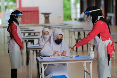 Muadzam Shah, Malaysia - April 7th, 2022 : New students made a quick Covid-19 test by placing saliva and fluid buffer observations during student enrolment day.