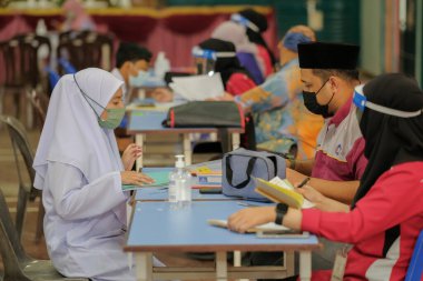 Muadzam Shah, Malaysia - April 7th, 2022 :  Happy muslim student with protective mask during  student enrolment day.