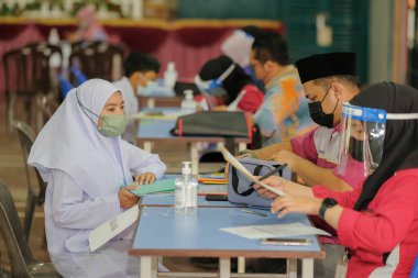 Muadzam Shah, Malaysia - April 7th, 2022 :  Happy muslim student with protective mask during  student enrolment day.