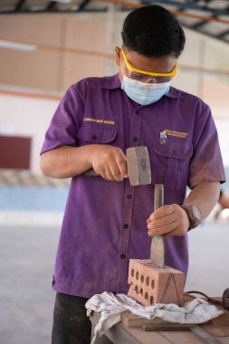 Muadzam Shah, Malaysia - August 25th, 2022: College students  working brick wall construction in bricklaying workshop