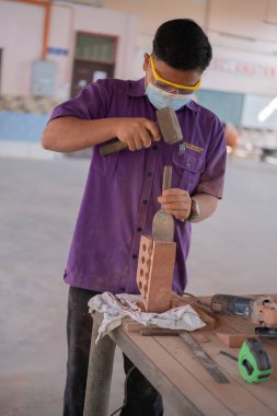 Muadzam Shah, Malaysia - August 25th, 2022: College students  working brick wall construction in bricklaying workshop