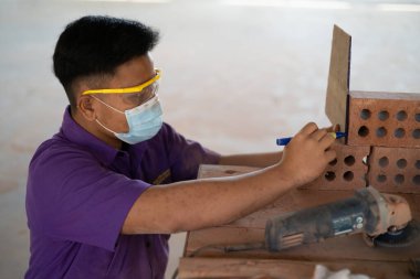 Muadzam Shah, Malaysia - August 25th, 2022: College students  working brick wall construction in bricklaying workshop