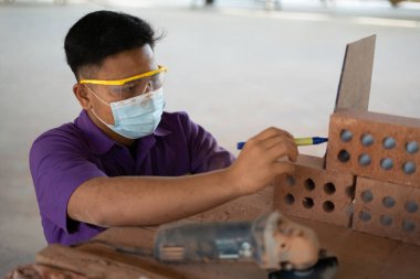 Muadzam Shah, Malaysia - August 25th, 2022: College students  working brick wall construction in bricklaying workshop